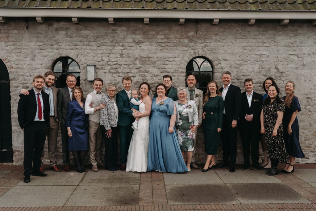 Het bruidspaar tijdens de groepsfoto's bij VRIJ Culemborg buiten